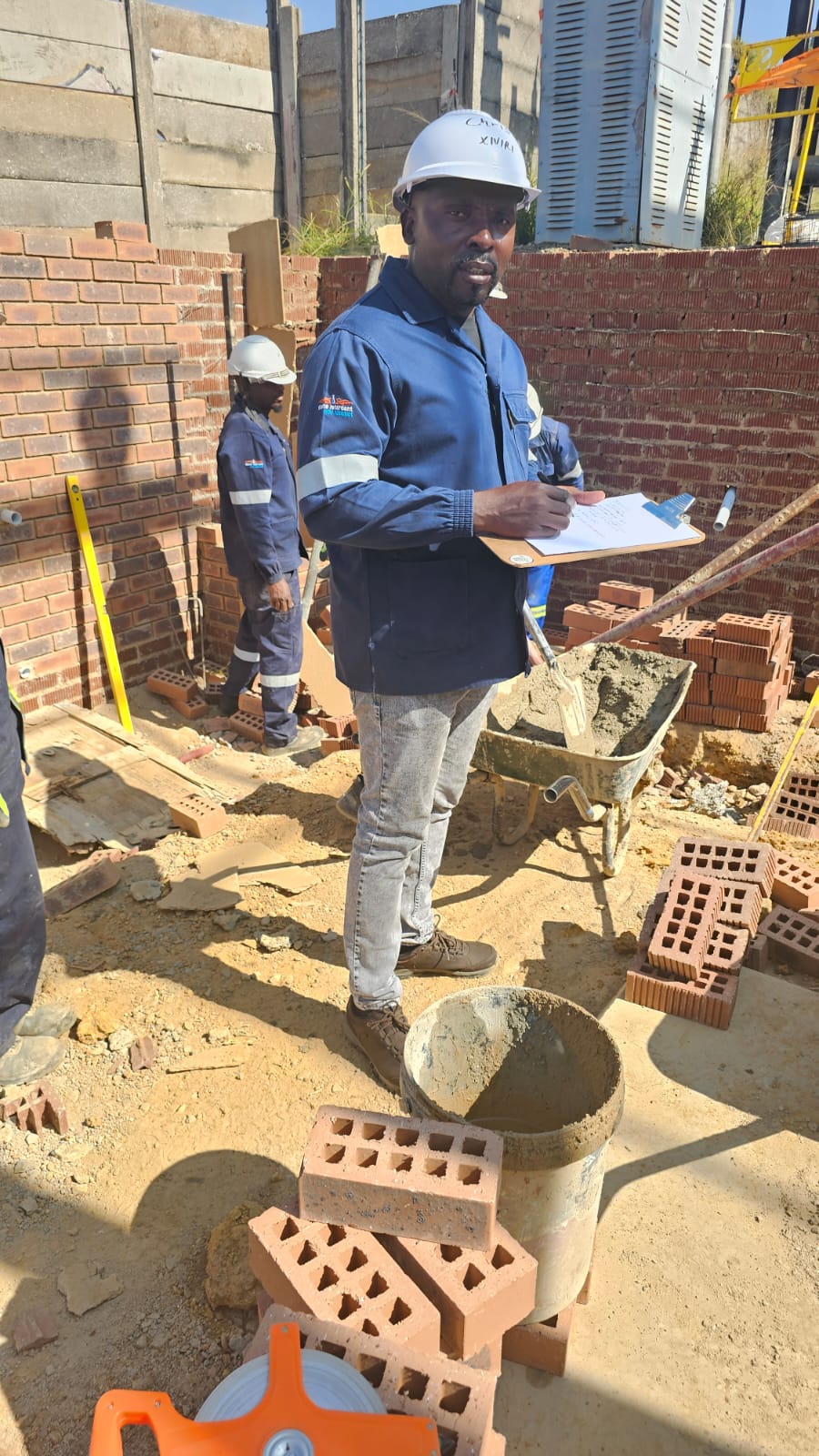 Concrete team at wall base